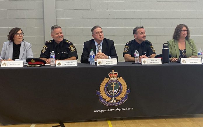 The Peterborough Police Service held a public meeting at the YMCA gym in downtown Peterborough on August 11, 2022. The speaker panel included (from left) Peterborough Police Services board chair Mary ten Doeschate, acting police chief Tim Farquharson, detective inspector John Lyons, operations division inspector Jamie Hartnett, and community development and engagement coordinator Emily Jones. While admitting the police service has dropped the ball on occasion in terms of its response to incidents, speakers assured the audience that addressing frontline officer and staff shortages will lead to a marked improvement moving forward.  (Photo: Paul Rellinger / kawarthaNOW)