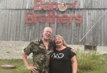 Andy and Linda Tough pose outside their Norwood area barn that has doubled as a recording studio for a number of years, not only allowing them to host live music jams on a regular basis but also record and produce live off-the-floor performances by a number of artists for 18 episodes of Live! At The Barn which were aired on Tough’s YouTube channel. The Toughs, whose property is up for sale, hosted one last jam on August 7, 2022. (Photo: Paul Rellinger / kawarthaNOW)