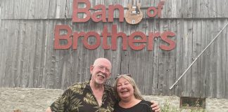 Andy and Linda Tough pose outside their Norwood area barn that has doubled as a recording studio for a number of years, not only allowing them to host live music jams on a regular basis but also record and produce live off-the-floor performances by a number of artists for 18 episodes of Live! At The Barn which were aired on Tough’s YouTube channel. The Toughs, whose property is up for sale, hosted one last jam on August 7, 2022. (Photo: Paul Rellinger / kawarthaNOW)