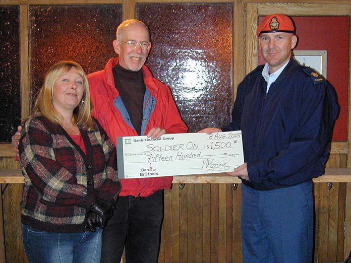 Linda and Andy Tough presenting a $1,500 cheque to Soldier On, a Canadian Armed Forces program that helps injured veterans and serving members. The proceeds were raised during their Band of Brothers fundraiser in 2009. (Photo courtesy of Andy Tough)