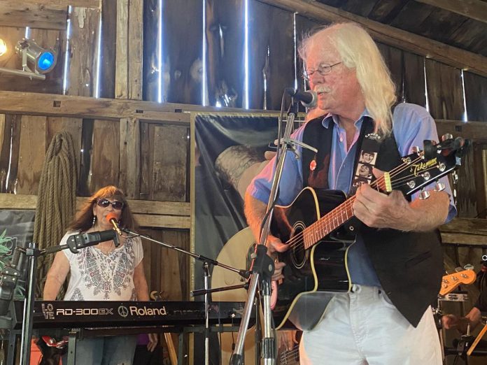 Rick and Gailie Young were among a number of local musicians who took to the stage on August 7, 2022 during the final live music jam held at Andy and Linda Tough’s Norwood area barn. Regular performers at past jams since day one, the longtime duo performed a number of songs from their extensive British Invasion music catalogue.  (Photo: Paul Rellinger / kawarthaNOW)  