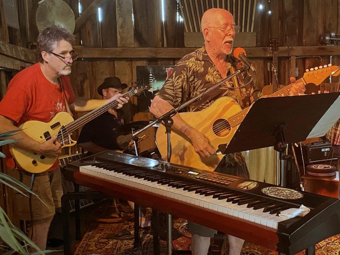 Andy Tough (right), who with wife Linda hosted the final music jam at their Norwood barn on August 7, 2002, got in on the fun by performing a few songs. (Photo: Paul Rellinger / kawarthaNO