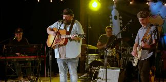 A performance by Donovan Woods and the Opposition is one of 12 featured in the Peterborough Folk Festival's concert film "We Can Do This', which documents the festival's four-day series of concerts during the pandemic in August 2021 at the Rolling Grape Vineyard in Bailieboro. The film premieres at the Market Hall in downtown Peterborough on August 18, 2022, just before the 2022 Peterborough Folk Festival. (kawarthaNOW screenshot)