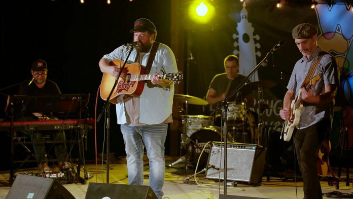 A performance by Donovan Woods and the Opposition is one of 12 featured in the Peterborough Folk Festival's concert film "We Can Do This', which documents the festival's four-day series of concerts during the pandemic in August 2021 at the Rolling Grape Vineyard in Bailieboro. The film premieres at the Market Hall in downtown Peterborough on August 18, 2022, just before the 2022 Peterborough Folk Festival. (kawarthaNOW screenshot)