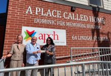 Glenn Wright (middle) and Margaret Cunningham and Jennifer Lopinski of the Community Foundation of Kawartha Lakes with a $7,500 for A Place Called Home at the non-profit organization's recently completed emergency shelter at 64 Lindsay Street South. (Photo courtesy of Community Foundation of Kawartha Lakes)