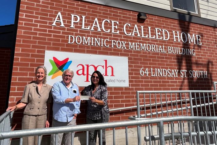 Glenn Wright (middle) and Margaret Cunningham and Jennifer Lopinski of the Community Foundation of Kawartha Lakes with a $7,500 for A Place Called Home at the non-profit organization's recently completed emergency shelter at 64 Lindsay Street South. (Photo courtesy of Community Foundation of Kawartha Lakes)