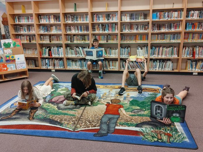 Students reading in the school library at Immaculate Conception Catholic Elementary School in Peterborough's East City. Studies show that in schools with well-staffed, stocked, and funded libraries score from 10 to 25 per cent higher on standardized tests than students in schools with poorly resourced libraries. (Photo: Nicole Tripp)