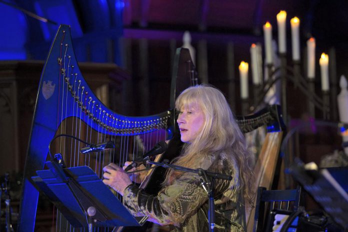 During her "Under A Winter's Moon" tour, Loreena McKennitt will sing and play harp, keyboard, and accordion, accompanied by musicians Caroline Lavelle, Graham Hargrove, Errol Fischer, Pete Watson, and Cait Watson. The concert will also feature readings by Tom Jackson (pre-recorded), Cedric Smith, and Jeffrey "Red" George. (Photo via Under A Winter's Moon website)