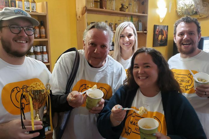 Owen Walsh of Sam's Place Deli, Peterborough DBIA executive director Terry Guiel, Ashlee Aitken of Kawartha Food Share, Peterborough DBIA communications and marketing manager Hillary Flood, and Dylan Reinhart of Boardwalk Board Game Lounge at the launch of the second annual  Peterborough Mac + Cheese Festival at The Food Shop on Water Street on September 28, 2022. (Photo: Jeannine Taylor / kawarthaNOW)