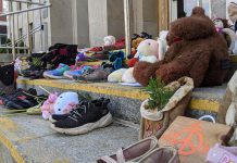 Children's shoes, toys, and offerings on the steps of Peterborough City Hall in June 2021, part of a community memorial created in response to the discovery of the remains of 215 Indigenous children buried at the former Kamloops Indian Residential School in British Columbia. As well as remembering and honouring those lost to residential schools and the thousands of survivors, National Day for Truth and Reconciliation is a day for Canadians to educate themselves about the heritage, culture, stories, and experiences of First Nations, Inuit, and Métis peoples. (Photo: Bruce Head / kawarthaNOW)
