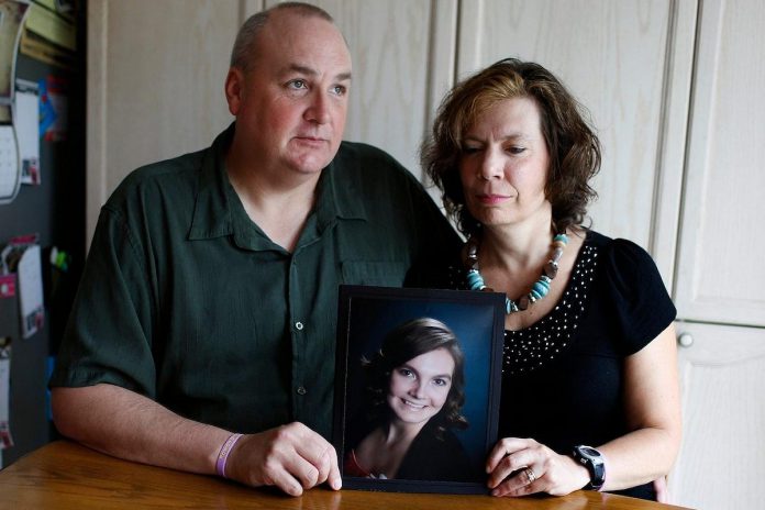 Gordon and Kathleen Stringer hold a picture of their 17-year-old daughter, Rowan, who died after suffering a concussion during a 2013 high school rugby game in Ottawa. She had continued to play despite suffering headaches as a result of blows to the head during previous games. (Photo: David Kawai)
