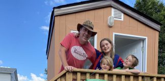 Peterborough teacher Aaron McFadden with his children at the prototype "tiny home" for people experiencing homelessness. McFadden will be sleeping in the cabin on Rubidge Street opposite Cathedral of St. Peter-in-Chains overnight on September 3, 2022 to raise awareness and funds for the Peterborough Action for Tiny Homes (PATH), a grassroots initiative with the goal of creating a village of 50 tiny homes to help house some of the 317 people without a home in Peterborough. (Photo courtesy of PATH)