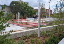 Workers at the urban park near the intersection of Charlotte and Aylmer streets in downtown Peterborough on September 13, 2022. (Photo: Bruce Head / kawarthaNOW)