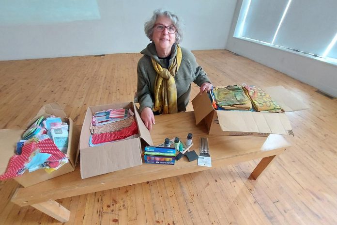 Community member Sue displays some of the art and craft supplies recently donated to Artspace Peterborough for its new maker space, scheduled to open in early 2023. (Photo: Artspace Peterborough / Facebook)