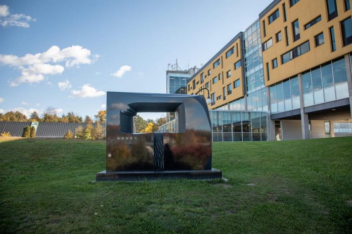 One of two sculptures entitled "Portal" by Canadian artist and Trent University alumnus David James. Located on the slope between the Chemical Sciences Building and Gzowski College, this sculpture weighs 3,600 kilograms and is carved from Belfast Black granite from South Africa. (Photo courtesy of Trent University)