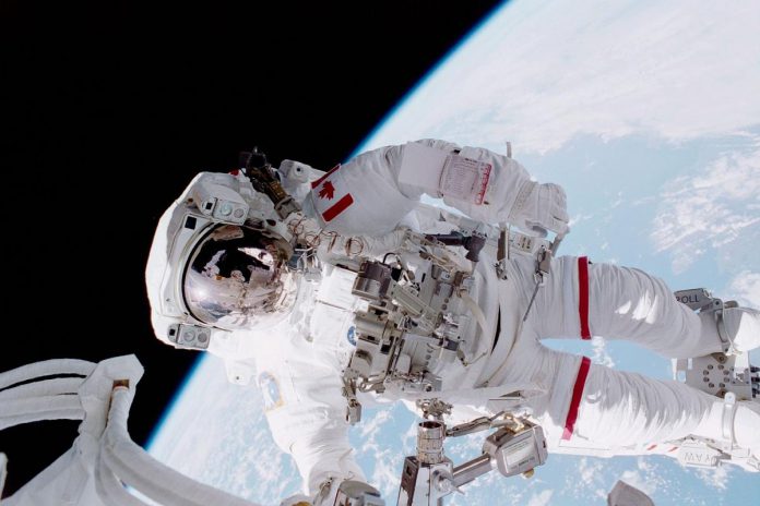The title of Kevin Lau's composition "Between the Earth and Forever" was inspired by former Canadian astronaut Chris Hadfield's caption in his book featuring this photo of Hadfield's first spacewalk taken by NASA astronaut Scott Parazynski during Hadfield's first spacewalk in April 2001 during a space shuttle mission to the International Space Station. (Photo: NASA)