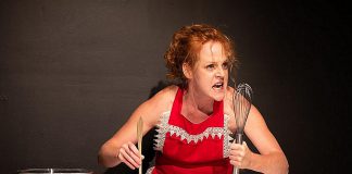 Peterborough theatre artist Sarah McNeilly, a two-time breast cancer survivor and sexual assault survivor, performing in her solo work "Titty Cakes: A Recipe for Radical Acceptance." During the performance, which contains mature themes, McNeilly will attempt to bake "Minne di Sant'gata" ("Saint Agatha's breasts"), a traditional breast-shaped pastry served during the Festival of Saint Agatha, the patron saint of breast cancer patients, rape victims, wet nurses, bakers, and bellfounders. (Photo: Andy Carroll)