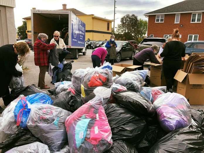 Volunteers sorting through donated winter outerwear during the United Way Peterborough & District's 2021 Coats for Kids (and Adults too!) collection. Now known as Coats for our Community, the annual collection takes place October 15 and 16, 2022 in Peterborough and Lakefield. (Photo: United Way Peterborough & District / Facebook)