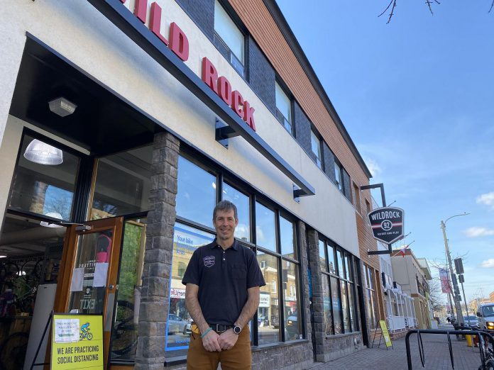 Scott Murison in front of the current Wild Rock Outfitters storefront in 2021. In 2003, Murison and Kieran Andrews took on partners Dave Woodfine and long-time employee Jonathan Moreno and launched the Bike Werks store, offering sales and service of mountain, road, and hybrid bikes. Eventually, they dropped the Bike Werks branding and bike sales and service were incorporated into Wild Rock Outfitters. (Photo: Ben Hargreaves / GreenUP)