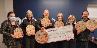 Alicia Vandine, donor relations and communications lead for Community Care Peterborough, with a cheque for $92,608.26 presented by local Tim Hortons owners Erika Howe-Gallagher, Ryan Graham, Donna Annett, and Mary and Greg Blair. (Photo courtesy of Community Care Peterborough)