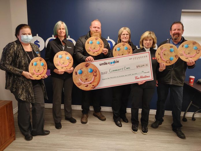 Alicia Vandine, donor relations and communications lead for Community Care Peterborough, with a cheque for $92,608.26 presented by local Tim Hortons owners Erika Howe-Gallagher, Ryan Graham, Donna Annett, and Mary and Greg Blair. (Photo courtesy of Community Care Peterborough)