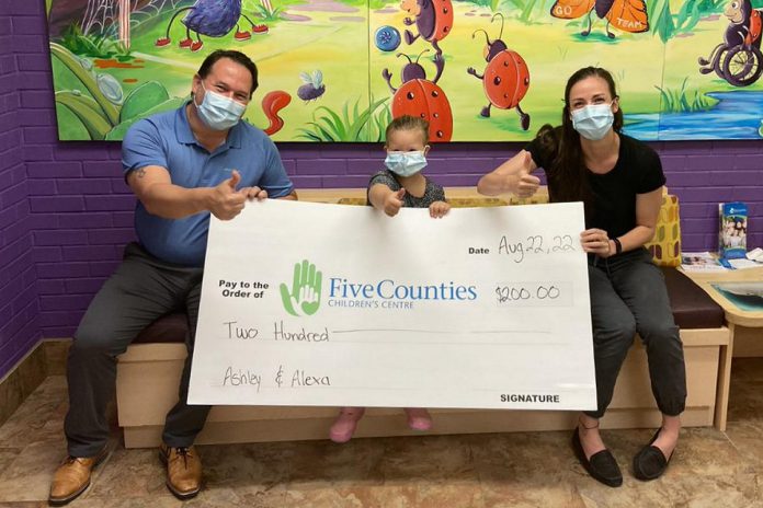Five Counties Children's Centre client Alexa (middle) with a cheque for $200 raised by her mother Ashley for the organization's Building Abilities For Life campaign. Also pictured is Five Counties CEO Scott Pepin (left) and annual giving coordinator Linsey Kampf. (Photo courtesy of Five Counties Children's Centre)