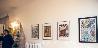 On display at Heather Doughty's studio during the First Friday Art Crawl on November 4, 2022, The Illustrated Boro Project featured 10 illustrations of downtown Peterborough businesses by five local artists. Also pictured is Mark Jokien, owner of Mark Jokinen Books, one of the featured businesses. (Photo courtesy of the Peterborough DBIA)