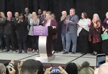 Labour leaders and representatives of public and private sector unions in Ontario and across Canada applaud after Laura Walton, president of the Ontario School Board Council of Unions (OSBCU) that represents education workers at the bargaining table, confirms at a media conference on November 7, 2022 that the provincial government will repeal its controversial Bill 28. (kawarthaNOW screenshot of CPAC video)