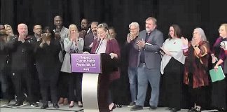 Labour leaders and representatives of public and private sector unions in Ontario and across Canada applaud after Laura Walton, president of the Ontario School Board Council of Unions (OSBCU) that represents education workers at the bargaining table, confirms at a media conference on November 7, 2022 that the provincial government will repeal its controversial Bill 28. (kawarthaNOW screenshot of CPAC video)