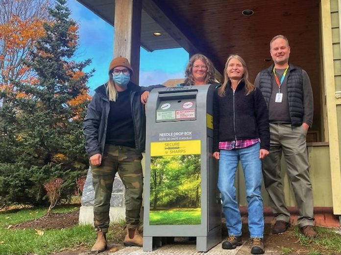 Pictured at one of the new needie disposal bins in Haliburton County is PARN harm reduction worker Katlin Archibald, Municipality of Dysart manager of programs and events Andrea Mueller, Haliburton Kawartha Pine Ridge District Health Unit health promoter Kate Hall, and Haliburton County Public Library CAO Chris Stephenson. (Photo courtesy of Haliburton Kawartha Pine Ridge District Health Unit)