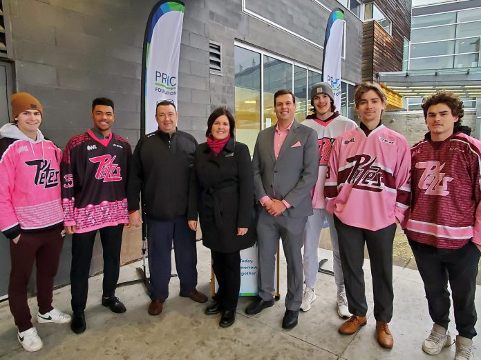 Peterborough Petes players wearing past Pink in the Rink jerseys flank Petes general manager Michael Oke, Peterborough Regional Health Centre (PRHC) Foundation president and CEO Lesley Heighway, and Petes executive director Burton Lee during a media announcement for the 2023 Pink in the Rink campaign at PRHC on November 30, 2022. (Photo courtesy of PRHC Foundation)