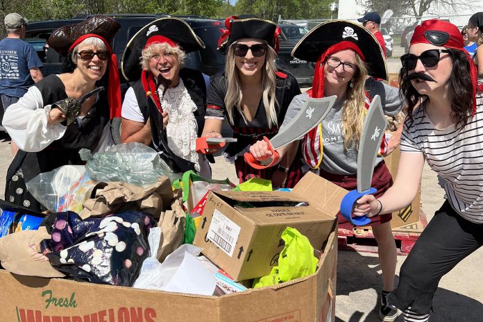 Porch Pirates for Good, a volunteer organization in Peterborough, collected more than 25,000 pounds of food during its spring food drive for Kawartha Food Share. The organization is hosting a fall food drive to restock the dwindling shelves at Kawartha Food Share on November 12, 2022. (Photo courtesy of Porch Pirates for Good)