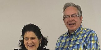 Peterborough mayor Jeff Leal (right) presents Madame Daphne Jane Rogers Molson with a citation recognizing the 75th birthday of the local poet, musician, and arts supporter at a celebration at the Peterborough Public Library on December 14, 2022. (Photo: Paul Rellinger / kawarthaNOW)