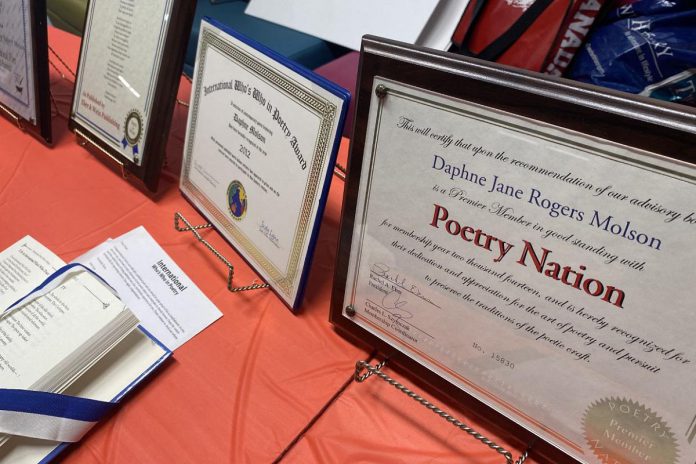 Some of the many certificates recognizing the literary accomplishments of Madame Daphne Jane Rogers Molson on display during her 75th birthday celebration at the Peterborough Public Library on December 14, 2022. (Photo: Paul Rellinger / kawarthaNOW)