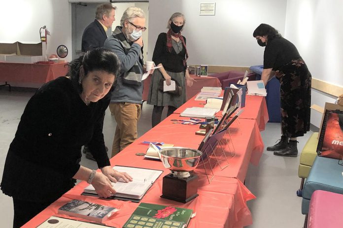 Madame Daphne Jane Rogers Molson (left) at a table featuring some of her works during her 75th birthday celebration at the Peterborough Public Library on December 14, 2022. (Photo: Eva Fisher)