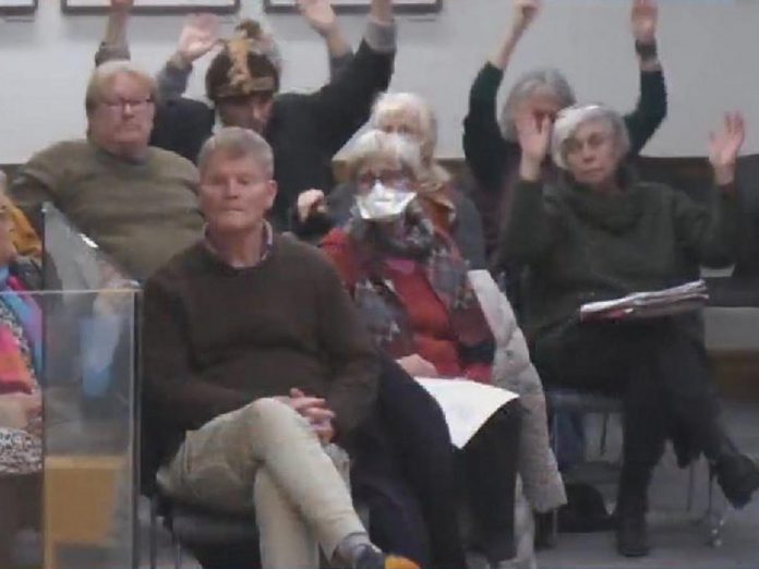 Members of the public wave their hands in support of comments made by Town Ward councillor Alex Bierk in support of one of his two motions to address the city's homelessness crisis at the inaugural general committee meeting of Peterborough's new city council on December 5, 2022. (kawarthaNOW screenshot of City of Peterborough livestream) 