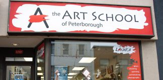 The Art School of Peterborough co-op student Cecilia Van Mierlo (left) and receptionist Raine Knudsen (right) hold up a snowflake ornament and first place award for their window display in the 2022 holiday window contest sponsored by the Peterborough Downtown Business Improvement Area (DBIA). As first-place winner, the school receives $1,000. Over 3,000 votes were cast online for 27 window displays at downtown businesses and organizations. (Photo courtesy of Peterborough DBIA)