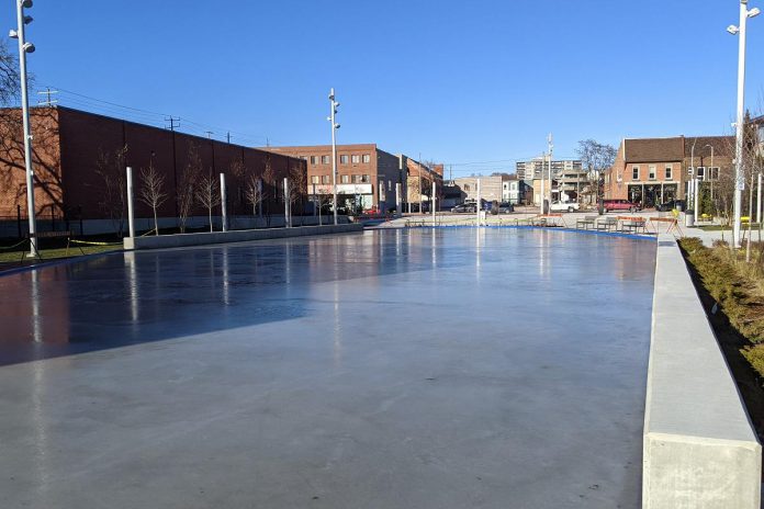 In advance of the community celebration at Quaker Foods City Square on December 17, 2022, city staff have been preparing the ice surface of the outdoor skating rink. Automatic bollard lighting surrounds the rink for night-time skating.  (Photo: Bruce Head / kawarthaNOW)