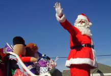 Santa in a sleigh during a Santa Claus parade. (Stock photo)
