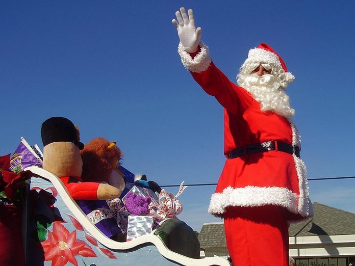 Santa in a sleigh during a Santa Claus parade. (Stock photo)