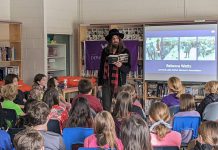 Hamilton-based musician, artist, and author Tom Wilson reads from his memoir "Beautiful Scars" during a December 8, 2022 event at Immaculate Conception Catholic Elementary School in Peterborough organized by the Gord Downie & Chanie Wenjack Fund in partnership with Sony Music Publishing. Wilson told the students about his discovery nine years ago, at the age of 54, that he was actually Indigenous. (Photo: Bruce Head / kawarthaNOW)