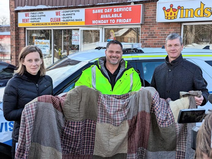 Fourcast manager Kerri Kightley, Peterborough County-City Paramedics deputy chief Craig Jones, and Windsor's Dry Cleaning Centre president Bruce Thompson outside Windsor's Dry Cleaning Centre at 655 Parkhill Road West in Peterborough during the announcement of the "Blankets for People" initiative on January 27, 2023. (Photo courtesy of Peterborough County)