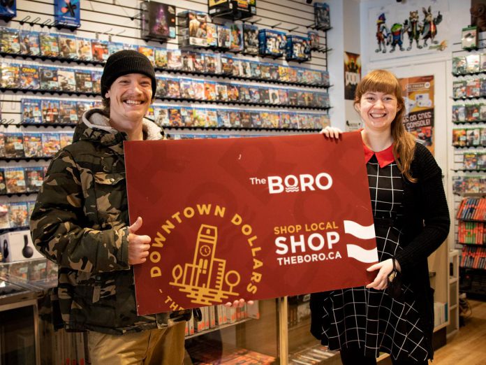 Holiday Shopping Passport grand prize draw winner Noah Sloan was presented with his grand prize of a $1,500 Boro gift card by Iceman Video Games store manager Holly Butler on January 14, 2023. Sloan completed his winning passport after purchasing a new game console at the downtown Peterborough business. (Photo courtesy of Peterborough DBIA)