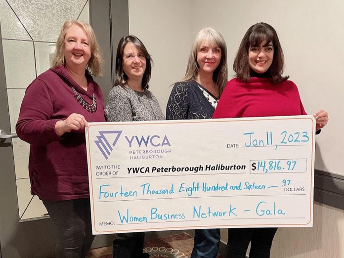 Women's Business Network of Peterborough president Diane Wolf (left) and program directors Tracy Minnema and Sandra Wilkins present a cheque for $14,816.97 to YWCA Peterborough Haliburton's lead philanthropc director Ria Nicholson (right) on January 11, 2023. The proceeds were raised during the Women's Business Network of Peterborough's December 2002 holiday gala and auction. (Photo: Grace Terfa / WBN)