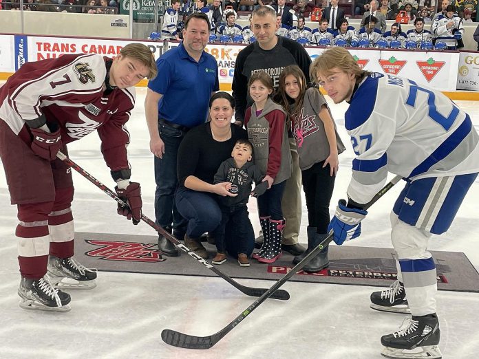 Five Counties Children's Centre CEO Scott Pepin (second from left) with the McDonald family, whose son Scott gets treatment at the centre, taking part in the ceremonial puck drop before the Peterborough Petes game on Family Day (February 20, 2023). While Five Counties is on track to support more than 6,000 kids/youth and their families in 2022-23, almost  2,000 area children are waiting for care up to two years. (Photo courtesy of Five Counties Children's Centre)
