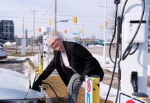 City of Peterborough councillor Joy Lachica at a city-owned Level 2 charging station. The public charging stations for electric vehicles are located at Del Crary Park, the Peterborough Memorial Centre, the Simcoe Street Parking Garage, and the King Street Parking Garage. (Photo: Lili Paradi / GreenUP)