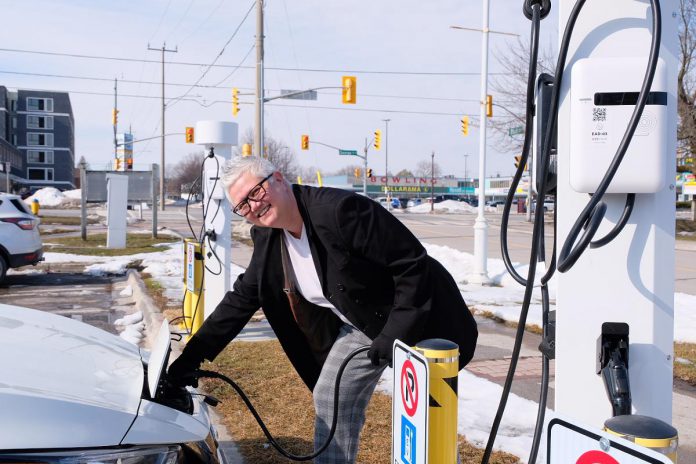 City of Peterborough councillor Joy Lachica at a city-owned Level 2 charging station. The public charging stations for electric vehicles are located at Del Crary Park, the Peterborough Memorial Centre, the Simcoe Street Parking Garage, and the King Street Parking Garage. (Photo: Lili Paradi / GreenUP)