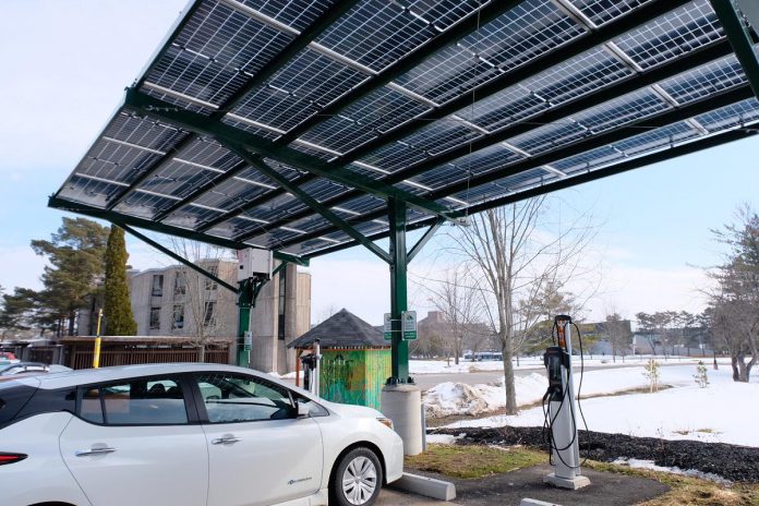 Trent University boasts a Level 2 charging station that also showcases its power supply: two-way solar panels both absorb the sun's rays and the light reflected off of parked electric vehicles underneath the panel. (Photo: Lili Paradi / GreenUP)