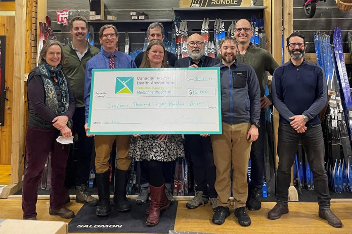 A cheque for $16,800 was presented to the Canadian Mental Health Association Haliburton, Kawartha, Pine Ridge (CMHA HKPR) at Wild Rock Oufitters in downtown Peterborough, representing the funds raised by an eight-hour ski relay event held on January 22, 2023 at the Kawartha Nordic Ski Club in North Kawartha Township. The proceeds will support CMHA HKPR's Garden Homes Project to support vulnerable individuals who are at risk of homelessness in the Peterborough area. (Photo courtesy of CMHA HKPR)
