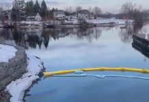 Containment barriers in place for a fuel oil spill, discovered on March 16, 2023, at the south end of Jackson Creek where it empties into Little Lake in downtown Peterborough. (kawarthaNOW screenshot of video by Christina Abbott)